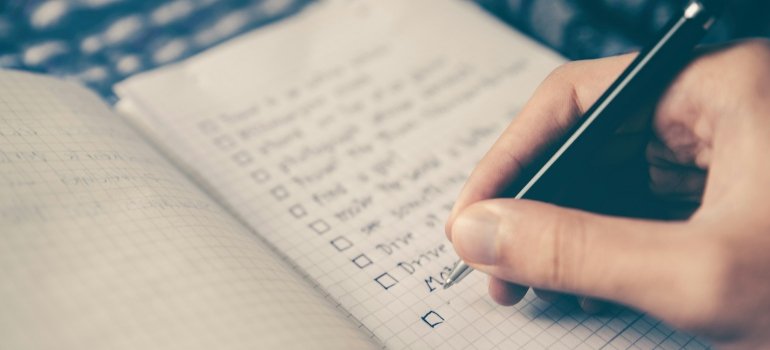 How to Ensure a Tech-Safe Move for Your Cincinnati Office 3 Person making a list