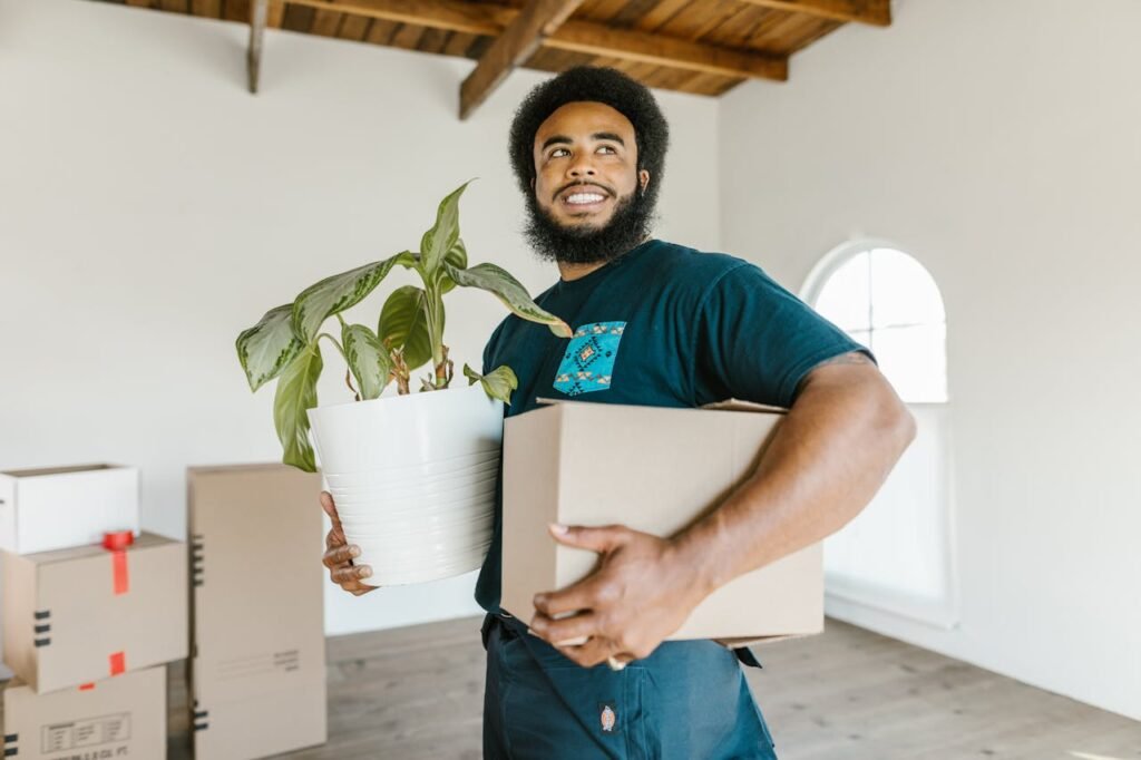 Top 5 Mistakes to Avoid When Moving in Cincinnati 2 a mover holding box and flower and helping people with mistakes to avoid when moving in Cincinnati
