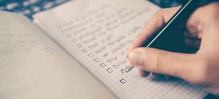 When Is the Best Season to Move in Maineville Ohio? 3 A person writing on a checklist