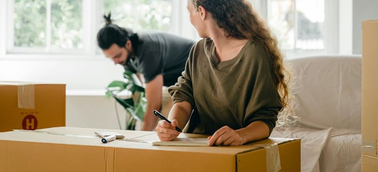 a couple packing furniture for a move