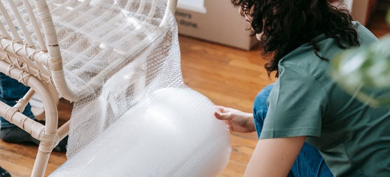 a woman preparing furniture for moving
