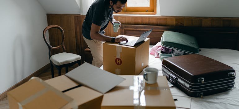 a person using a laptop learning how to downsize for a move
