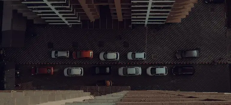 Is Cincinnati a good place to live? 3 Aerial view of a parking lot with neatly arranged cars, surrounded by a modern building's facade