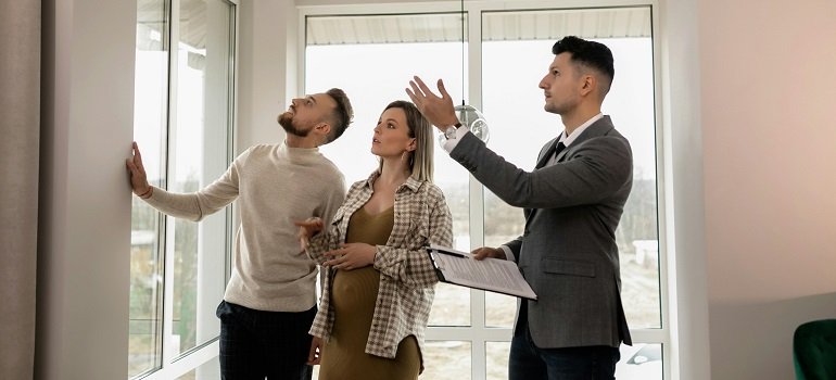 Couple touring new Milford home with real estate agent