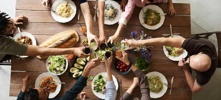 Friends raising glasses during a shared meal