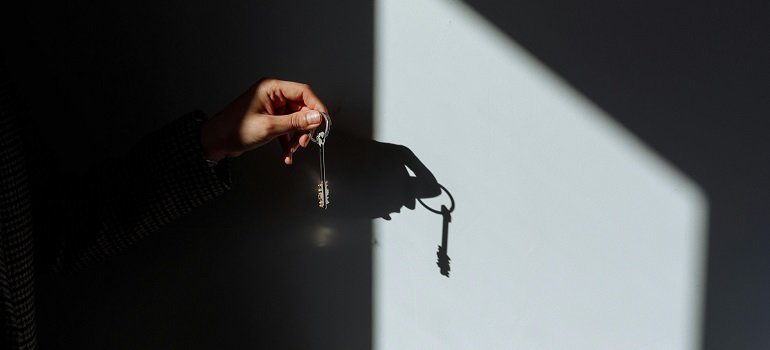person holding house keys