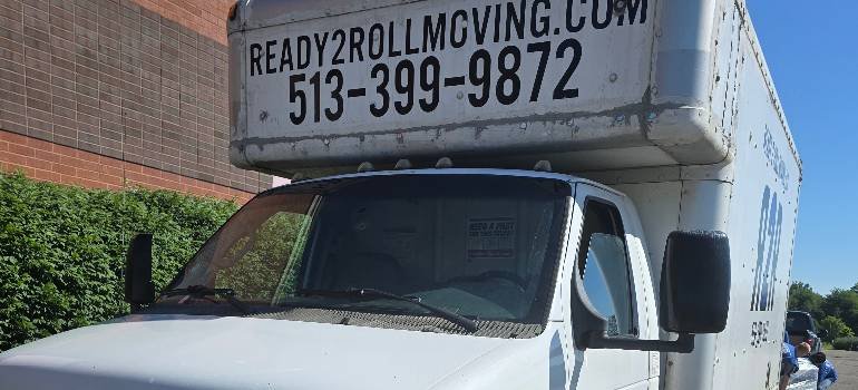 Ready2Roll moving truck parked beside brick building