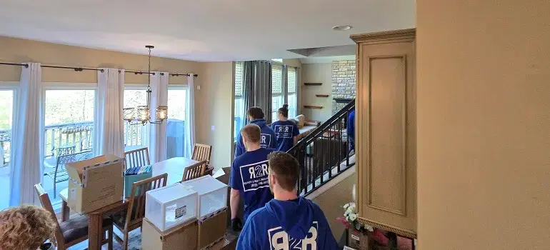 4 easy items to get rid of before moving 1 Movers carrying packed furniture out of a house