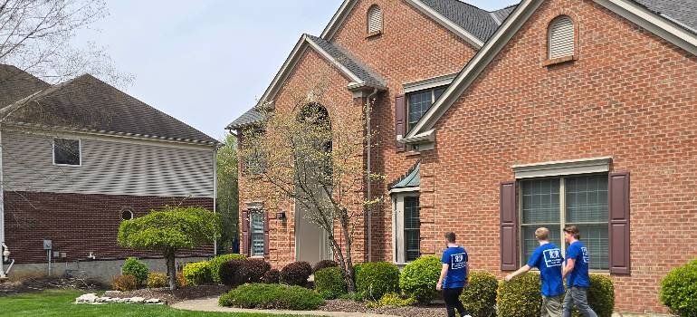 Your spring guide to moving to Morrow 6 Crew approaches large brick house for move-in