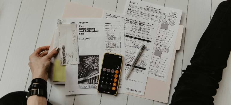 Your spring guide to moving to Morrow 5 Tax papers and calculator for budgeting moving to Morrow