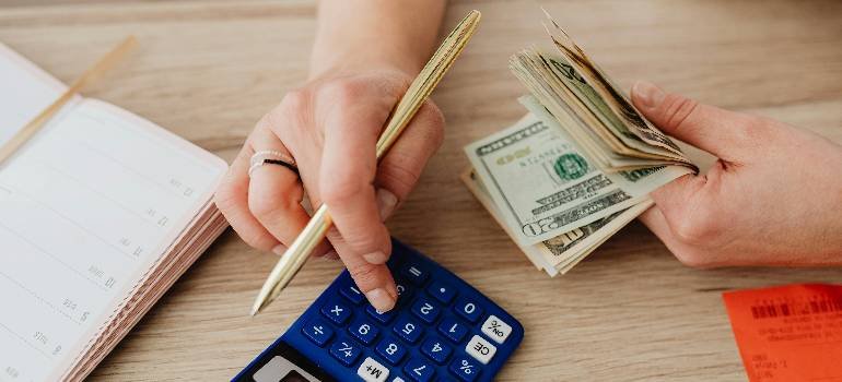 Budgeting moving costs with cash and calculator