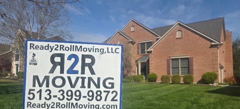 a yard sign in front of a home with the number of safe movers Cincinnati based