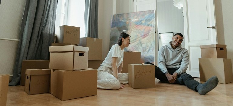 Essential steps to take before moving into your new Milford apartment 2 Happy pair unpacking after moving