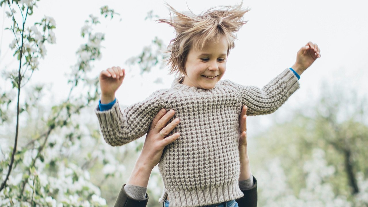Child lifted outdoors enjoying funs things to do in Mason OH this spring