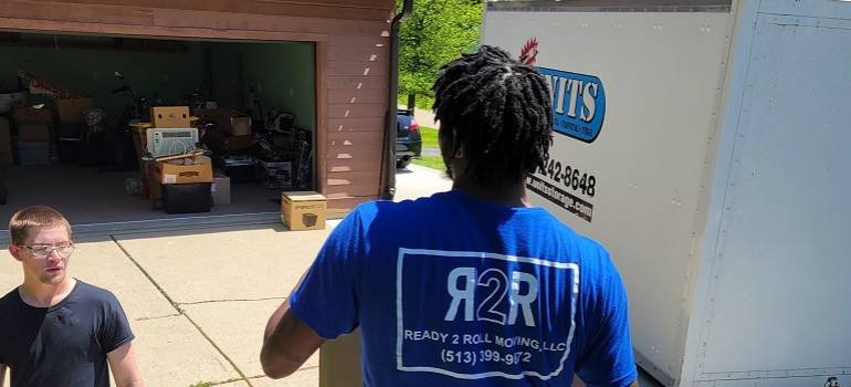 How to move a bolted-down safe in Cincinnati? 2 a moving professional in a blue shirt preparing to move a bolted-down safe in Cincinnatii