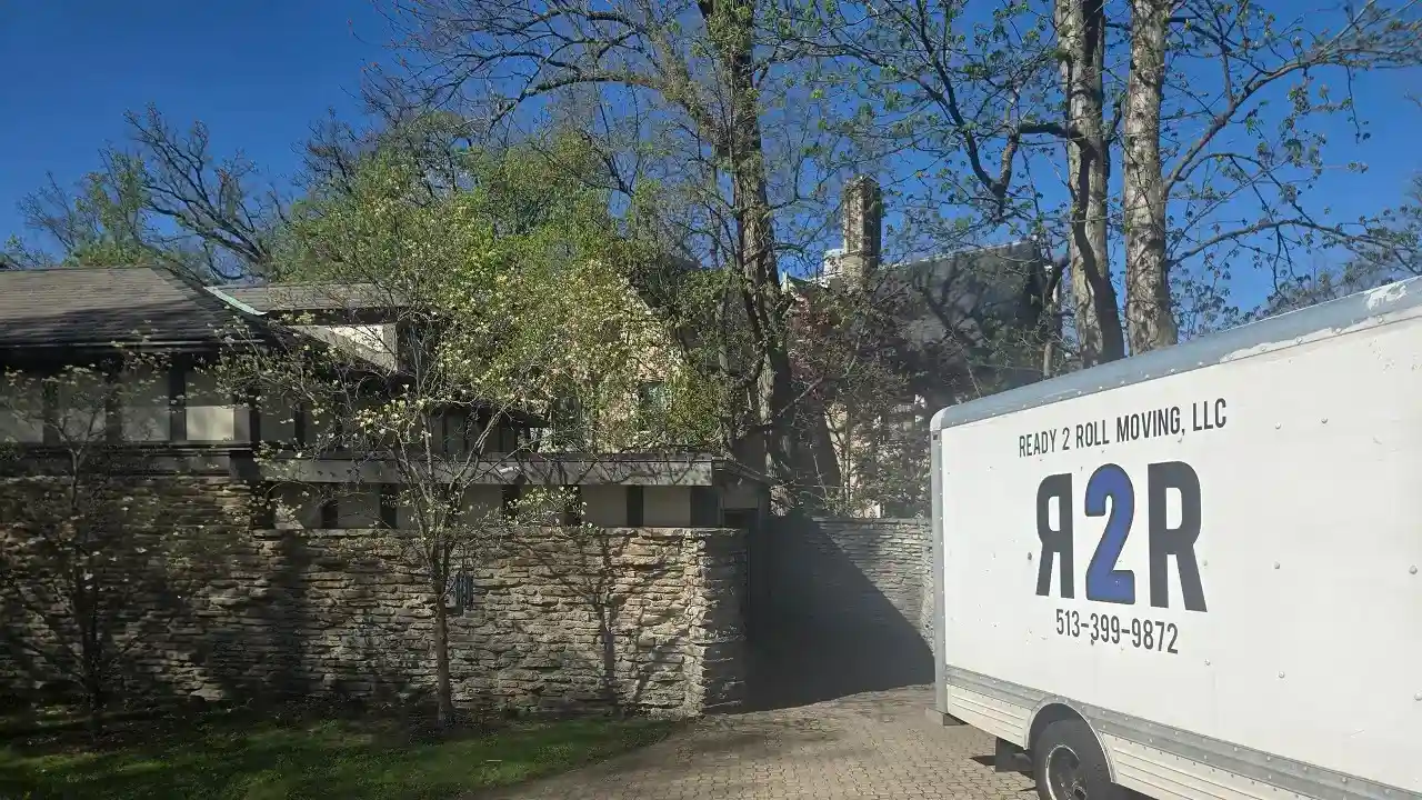 a moving truck in front of a rural area