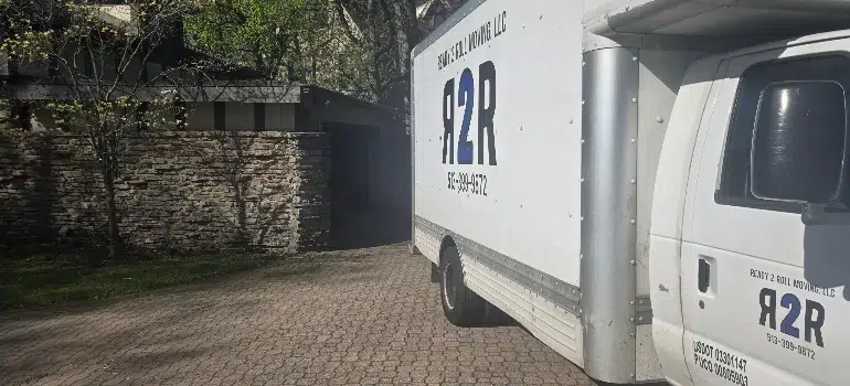 A white truck parked in front of a residential house on a clear day.