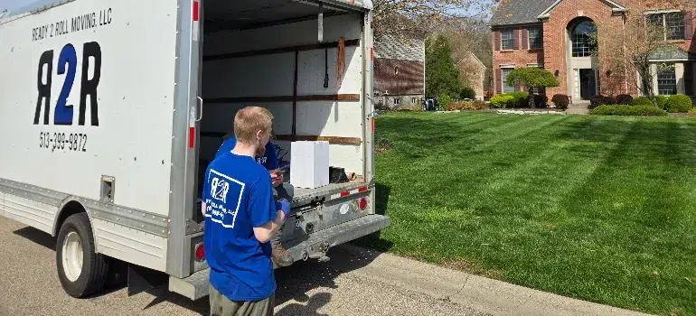 A man in a blue shirt, delivering packing services to clients
