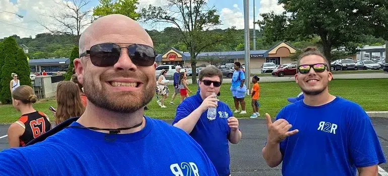 Maineville Movers 2 a team of Maineville movers, after a successful move, enjoying a break with their clients in a park
