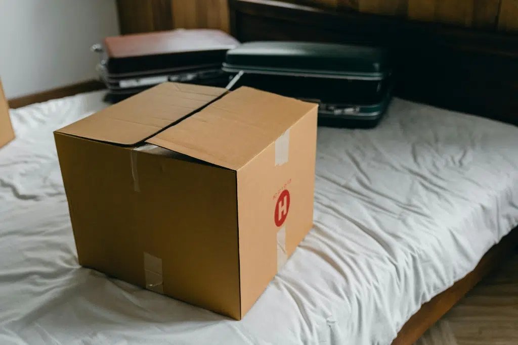 Suitcase and packed boxes, ready for a fresh start after deciding on moving to a new city alone.