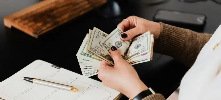 How To Plan A Long Distance Move To Cincinnati 2 a woman counting money