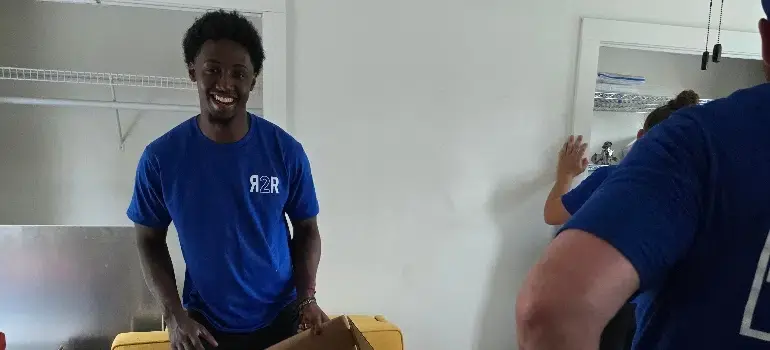 Local Movers 4 mover preparing furniture for move with a smile on his face