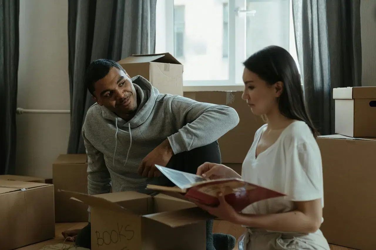a couple packing moving boxes