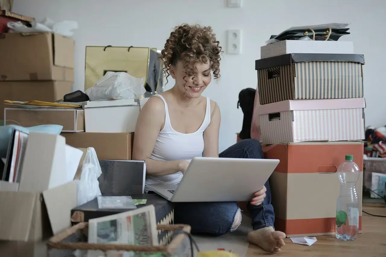 a woman sitting in cluttered room
