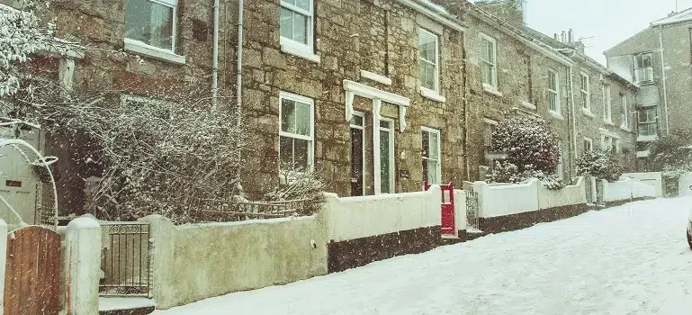 Rowhouses along steep hills and icy streets during December moves