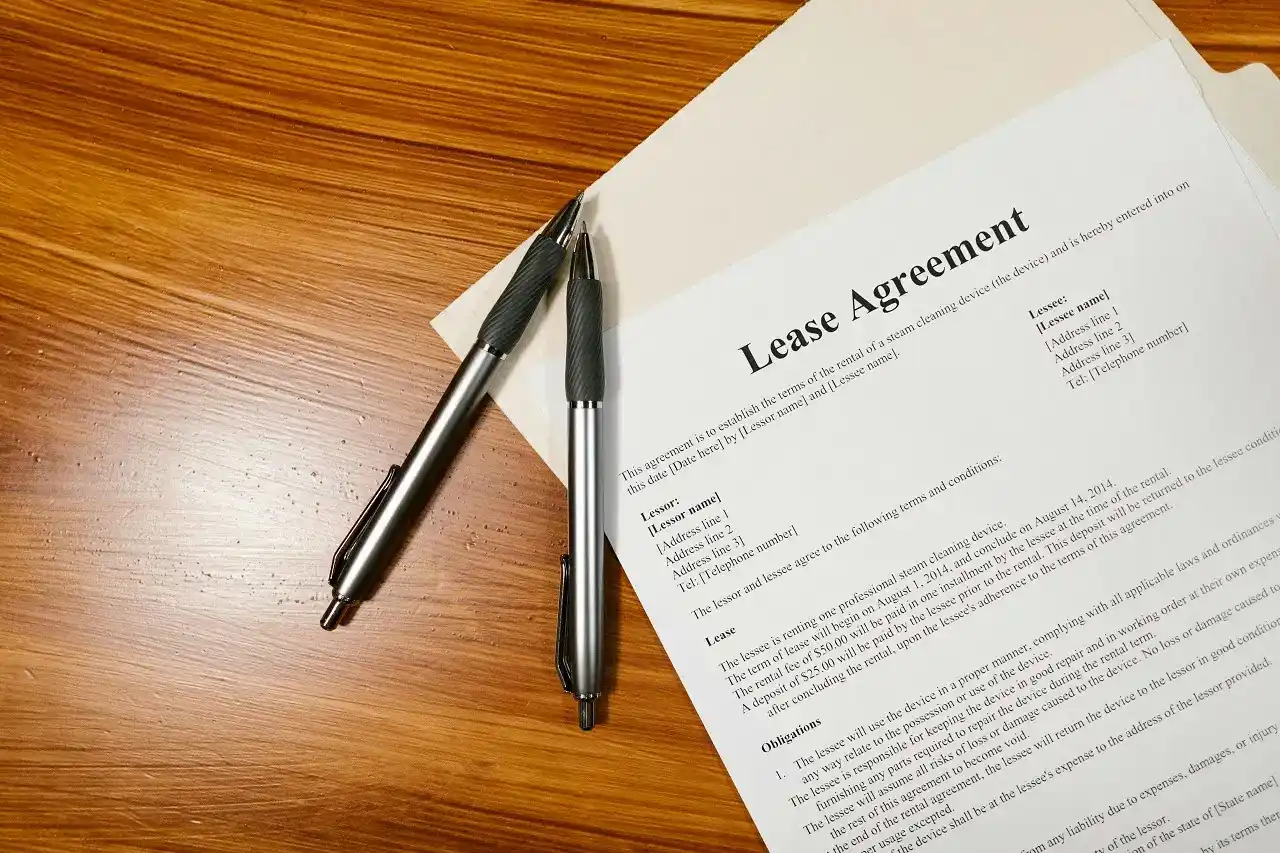 ase agreement with pens showing apartment lease terms in Cincinnati paperwork.