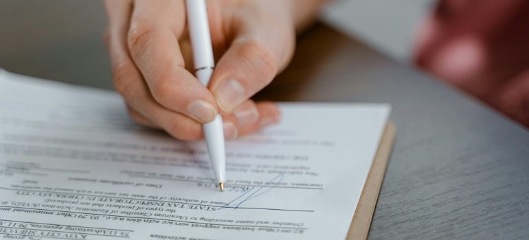 Essential paperwork you cannot ignore after moving to West Chester OH from out of state 1 a person signing forms for moving to West Chester OH from out of state