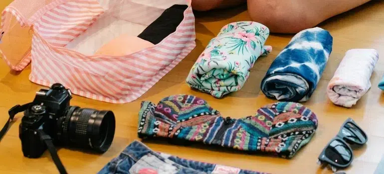 Woman using the best way to pack clothes for moving and save space