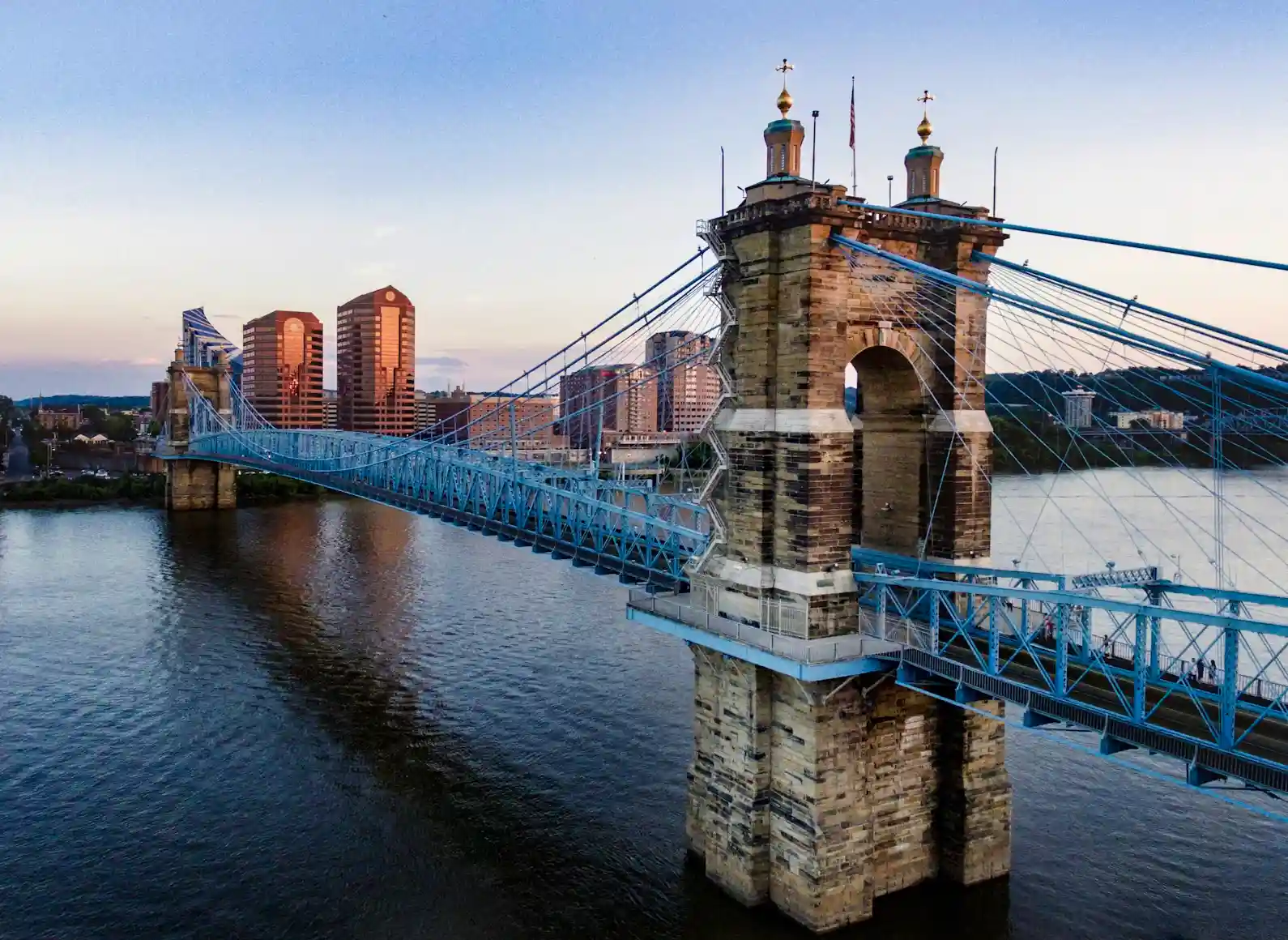 A bridge over water with buildings in the background.