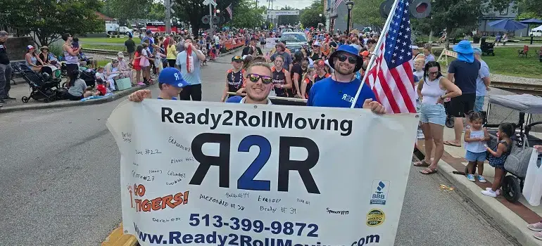 Team of movers lebanon ohio​ based  holding Ready2Roll Moving banner