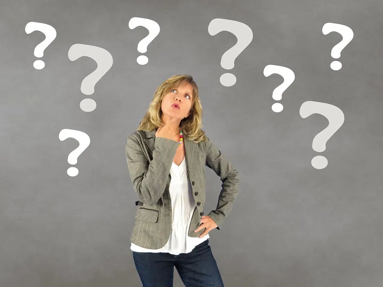 A woman surrounded with question marks because she doesn't know the best time to move in Maineville Ohio.
