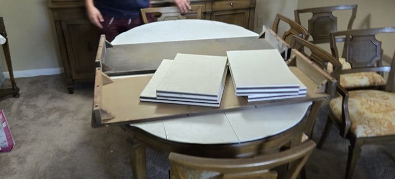 Table packed with cardboard pieces for moving