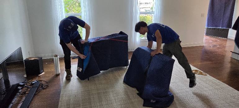 Residential Movers 2 Movers wrapping furniture for a move