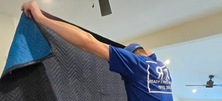 Monroe movers protecting furniture inside a local home